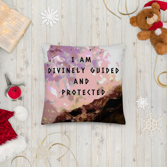 18x18 inch premium pillow. All-over print, purple, pink, and brown amethyst, with spiritual wise quote/mantra/slogan/saying/tagline, front of pillow. "I Am Divinely Guided And Protected." Shown with teddy bear, book and Christmas hat. Pre-shrunk, 100% polyester. Machine washable case with shape-retaining insert. JAMILLIAH'S WISDOM IS TIMELESS SHOP - wisdomistimeless.com.