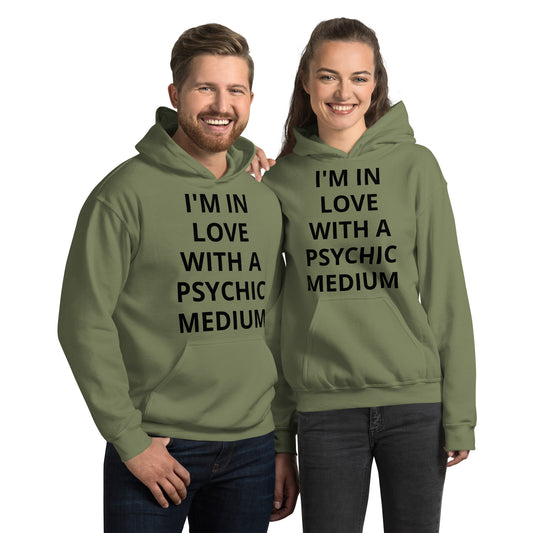 Military green, unisex, heavy blend, hoodie, front. Otherworldly, supernatural quote. "I'm In Love With A Psychic Medium." Worn by female and male couple. JAMILLIAH'S WISDOM IS TIMELESS SHOP - wisdomistimeless.com.