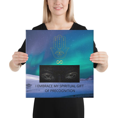 16x16 inch canvas print. Landscape with logo and slogan/saying/tagline. Original hamsa hand/infinity logo, northern lights/polar lights/aurora borealis sky, and authentic psychic's eyes design. Supernatural wise quote mantra, "I Embrace My Spiritual Gift Of Precognition." - Jamilliah - Shown with female model holding the canvas art print. JAMILLIAH'S WISDOM IS TIMELESS SHOP - wisdomistimeless.com.