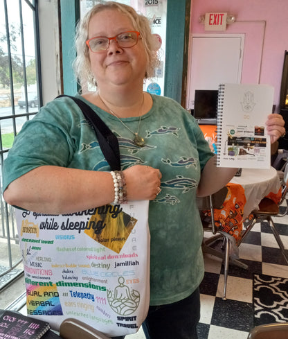 Satisfied female customer with purchases. All-over print, colorful, spiritual awakening collage on large tote bag with black straps. Also shown with Lightworker Journals/Notebooks. Jamilliahs Wisdom Is Timeless Shop - wisdomistimeless.com.