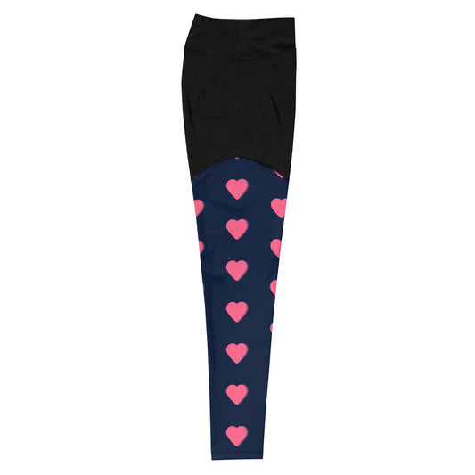 High-waisted, 7/8 length, compression sports leggings. Designed with stylish black and navy blue colors and fun pink hearts with purple accents. Made with polyester/spandex blend compression fabric, built-in, double-layered belt, sewn-in gusset, and inside, back pocket. Slimming look and butt-lifting cut. Right leg view. JAMILLIAH'S WISDOM IS TIMELESS SHOP - wisdomistimeless.com.