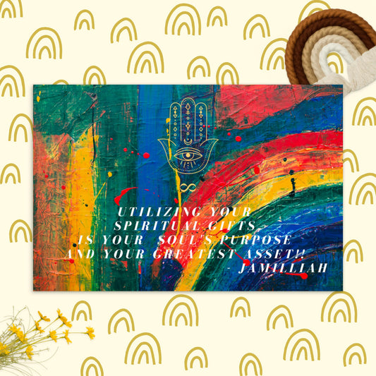4"x6" cardboard, glossy, postcard. Hamsa hand and infinity symbol brand logo, and original wise quote/mantra/saying/motto/tagline/slogan. "Utilizing Your Spiritual Gifts Is Your Soul's Purpose And Your Greatest Asset!!" - Jamilliah. Rainbow paint design. Shown with person writing on the postcard. JAMILLIAH'S WISDOM IS TIMELESS SHOP - wisdomistimeless.com.