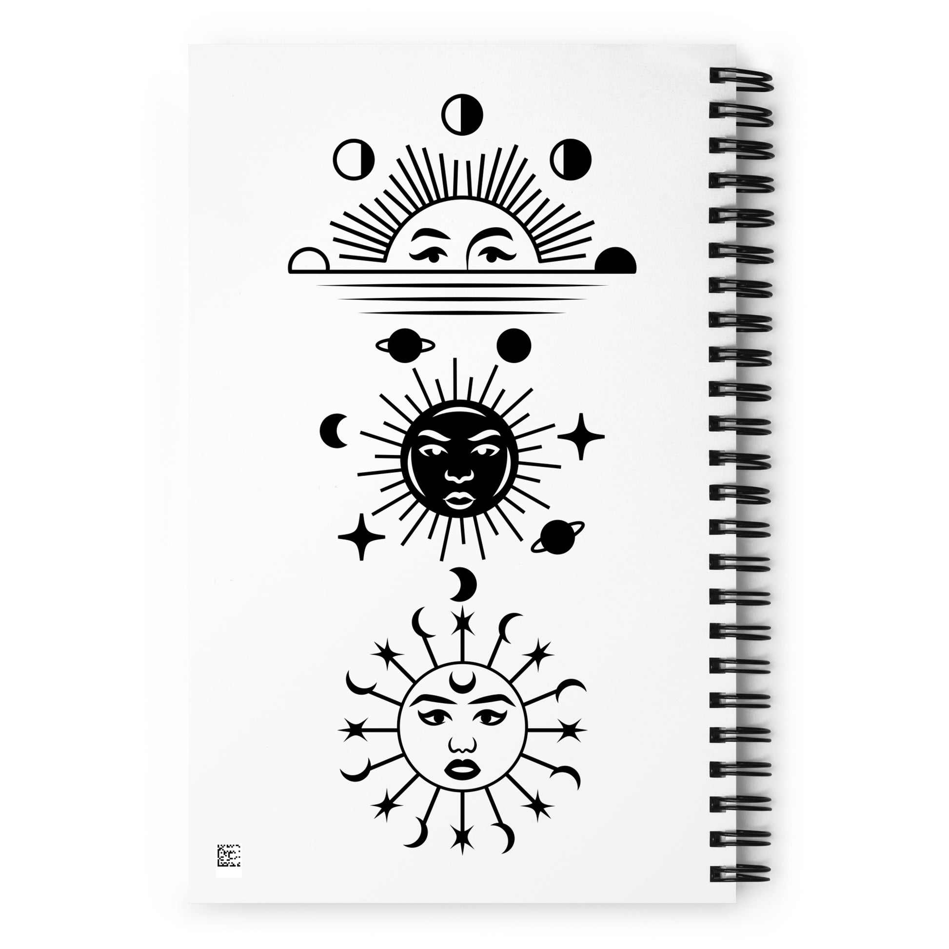 Manifesting journal/spiral notebook, back view. 140 dotted pages. 5.5 inches x 8.5 inches. Black and white images of moons in different phases, sun set, suns with faces, stars, and solar system planets. Jamilliah's Wisdom Is Timeless Shop - wisdomistimeless.com.