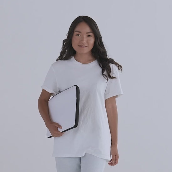 Live video of female model showcasing laptop sleeve. Product details of style, size, front, inside, and back. 100% neoprene, double zipper and faux fur interior lining. White with a black back. JAMILLIAH'S WISDOM IS TIMELESS SHOP - wisdomistimeless.com.