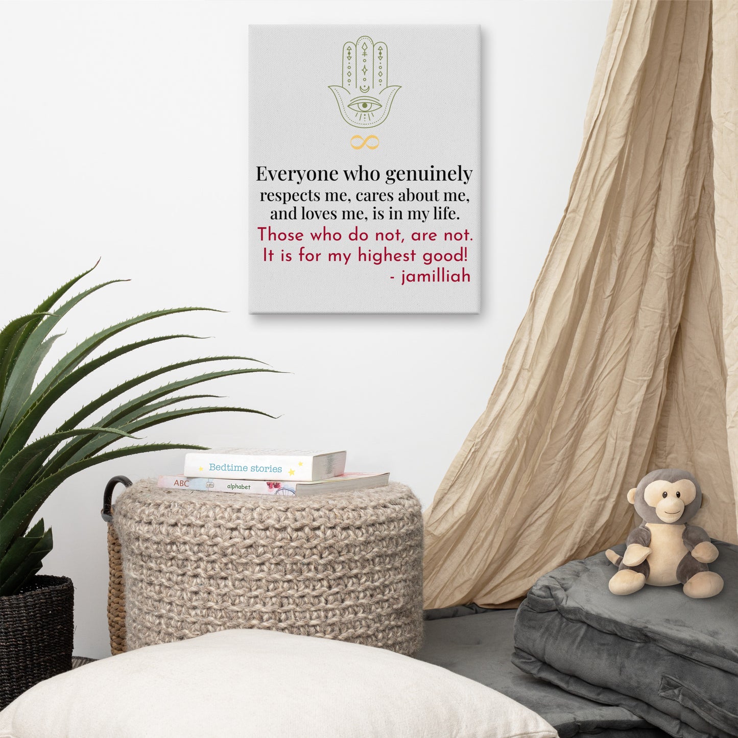 Whisper white/grey, 12x16 inch canvas print wall art. Vertical presentation. Spiritual, supernatural green hamsa hand and yellow infinity sign logo images. Original wise quote, mantra, slogan, saying; written in black and red. "Everyone Who Genuinely Respects Me, Cares About Me, And Loves Me, Is In My Life. Those Who Do Not, Are Not. It Is For My Highest Good!" - Jamilliah - Shown on white wall, surrounded by a plant, books, curtain, and furniture. JAMILLIAH'S WISDOM IS TIMELESS SHOP - wisdomistimeless.com.